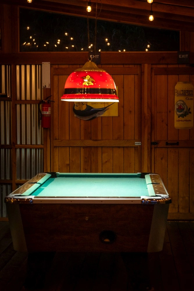Ocean Cove Lodge pool at night with glowing lights and deck seating