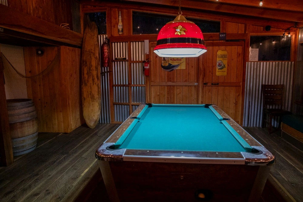 Ocean Cove Lodge outdoor pool at night with ambient lighting and loungers